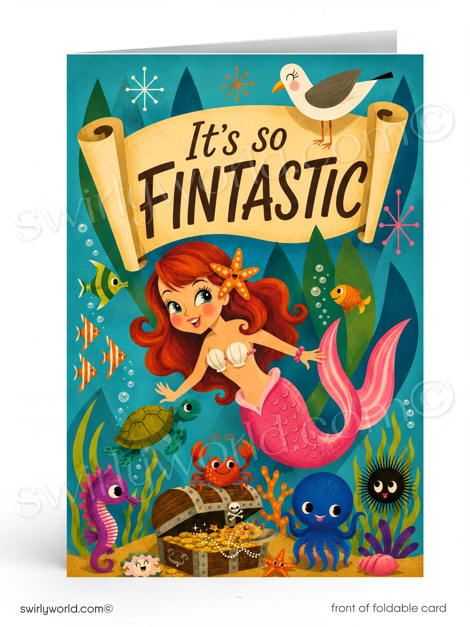 A colorful folded greeting card featuring an underwater mermaid scene with the text 'It's so FINTANTIC' on a scroll banner. The card shows a mermaid with red hair and a pink tail, surrounded by fish, a crab, a treasure chest, a seahorse, a blue octopus, a black sea urchin, and a seagull at the top.