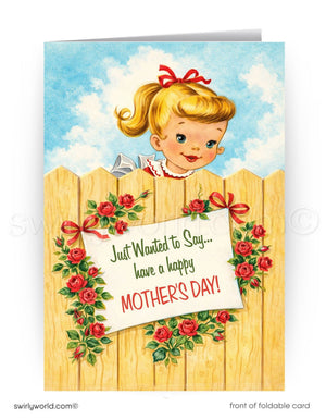 A greeting card featuring a young girl peeking over a wooden fence, with a sign that reads "Just Wanted to Say... have a happy Mother's Day!" The card has a floral border and a blue sky background.
