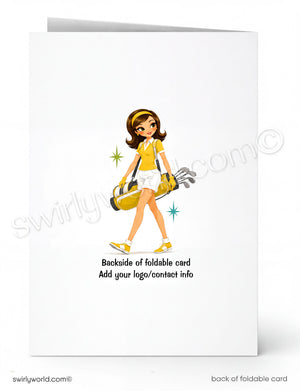 A folded white greeting card shown front and back on a white background. The front features a cartoon illustration of a woman in a yellow and white outfit carrying a golf bag, with small star accents.
