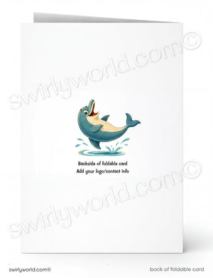 A folded white greeting card shown front and back on a white background. The front has a small cartoon blue-gray dolphin jumping with an open mouth, and the back has placeholder text reading 'Backside of foldable card' and 'Add your logo/contact info'.