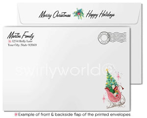 The image is a printed envelope with a Christmas-themed design, including a Christmas tree and a sleigh. The envelope has a "Merry Christmas" and "Happy Holidays" greeting, and the address "Martin Family" is printed on it. The back of the envelope has a postmark and a stamp, and there is an example of the front and backside flap of the printed envelopes.