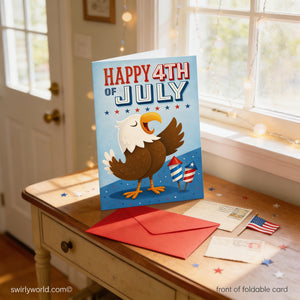 A colorful card celebrating the 4th of July, featuring an eagle and fireworks, sits on a wooden table with a red envelope and some postcards.
