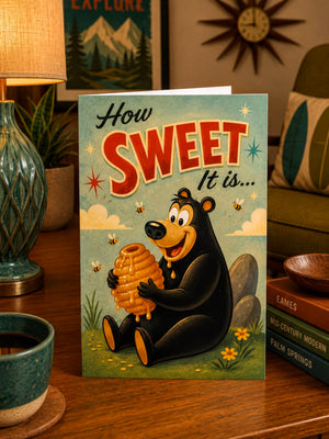 A greeting card featuring a cartoon bear holding a honeycomb, with the text "How Sweet It is..."