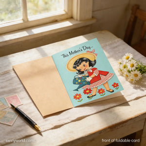 A handmade Mother's Day card with a young girl in a red dress and straw hat, surrounded by flowers, sits on a wooden table with a pen and some postage stamps.