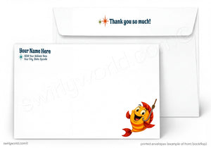 A printed white envelope set shown on a light gray background. The front envelope has a cartoon orange fish character with a red tail and yellow smile, while the back envelope has blue placeholder text and a small starburst icon next to it.