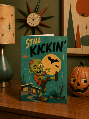 a Halloween-themed greeting card with a zombie character, a pumpkin, and a clock on the wall.