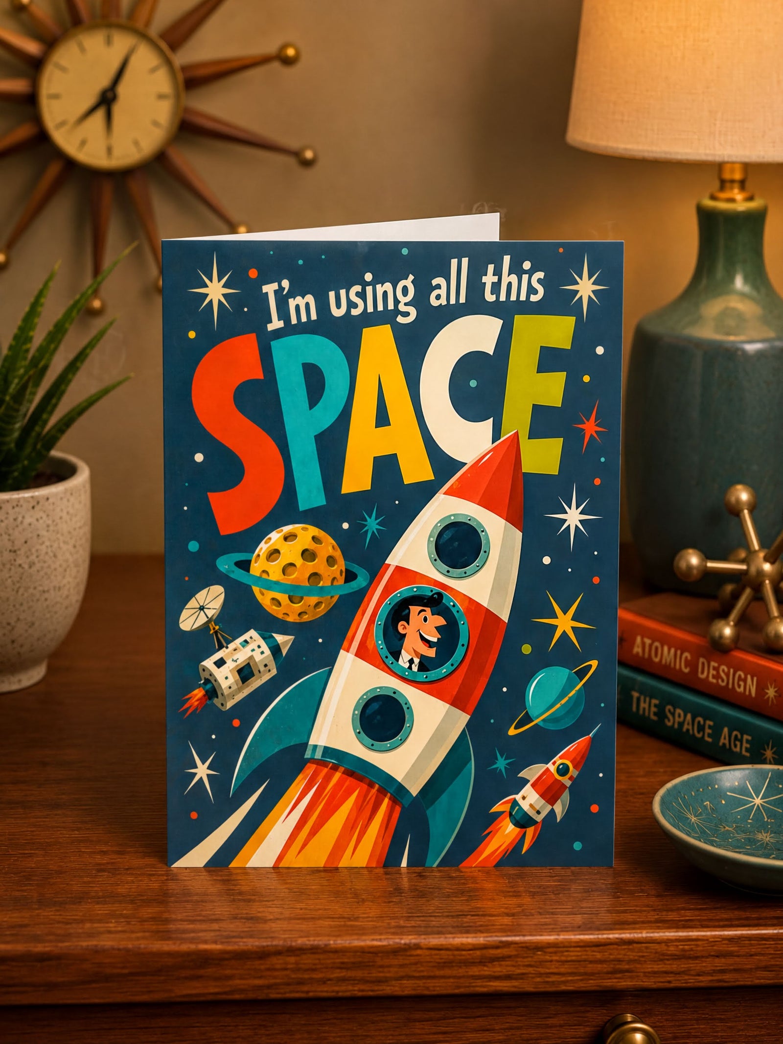 Card with a colorful rocket and space-themed text on a blue background