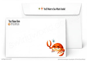 A white printed envelope set shown on a light gray background. The front envelope has a cartoon orange crab illustration near the lower right corner, placeholder text reading 'Your Name Here' and 'Add Your Address Here' on the upper left, and a thank-you message on the flap.