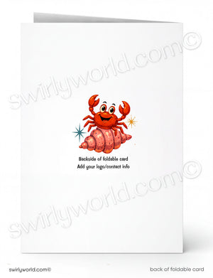 A folded white card shown front and back on a white background. The front features a cartoon red-orange crab sitting on a pink shell with small star accents.