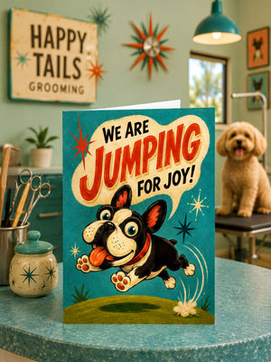 A greeting card with a dog jumping in the air, surrounded by a whimsical design, is displayed on a table with various items such as a potted plant, a star-shaped ornament, and a small dog.