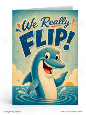 A folded greeting card shown front-on against a white background. The card features a retro-style illustration of a smiling blue dolphin rising from water with the text 'We Really FLIP!' in large navy lettering.