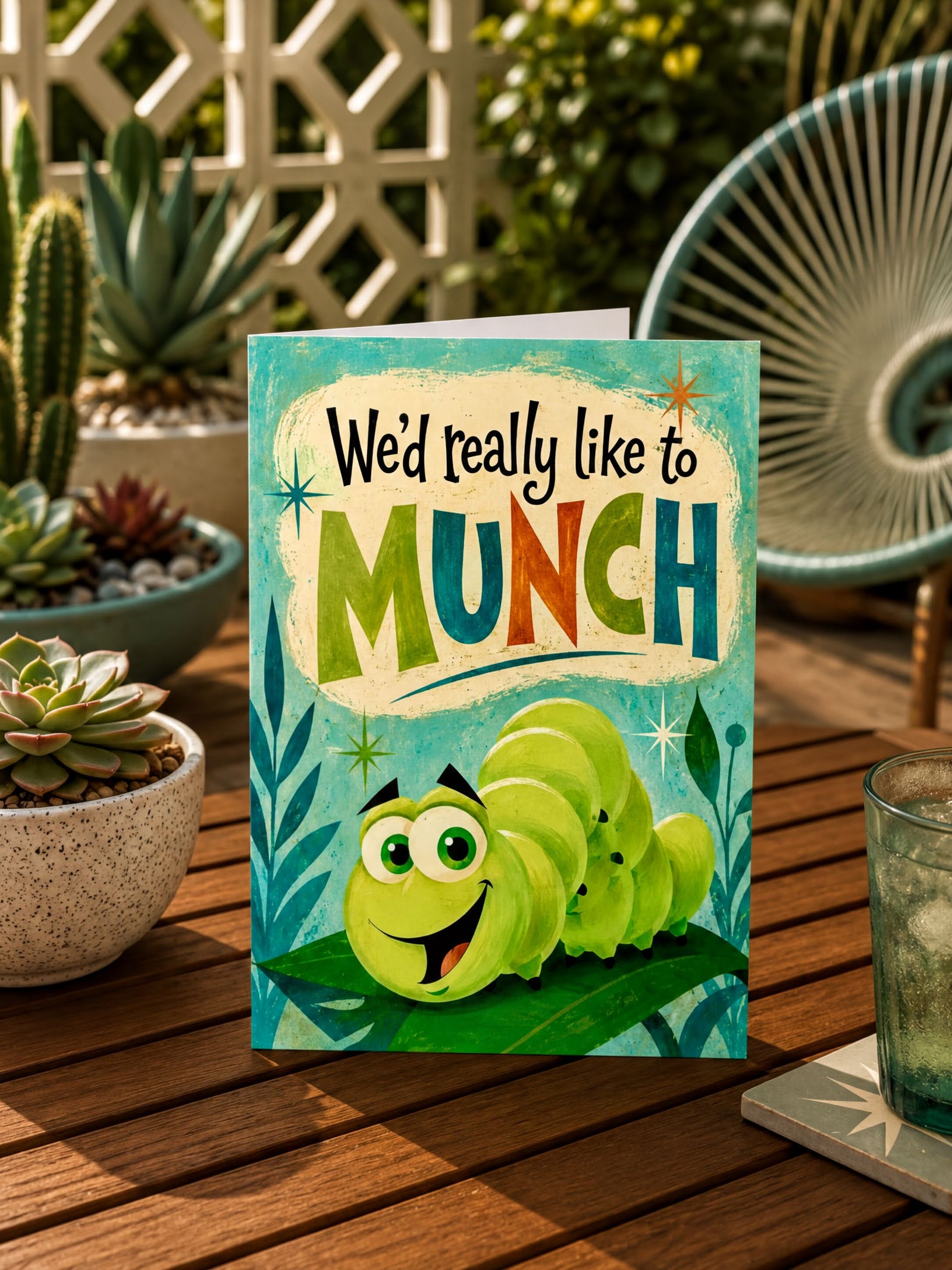 The image is a colorful greeting card featuring a cartoon caterpillar with large eyes and a smiling expression, sitting on a leaf. The text on the card reads "We'd really like to MUNCH", and there are stars and leaves surrounding the caterpillar.