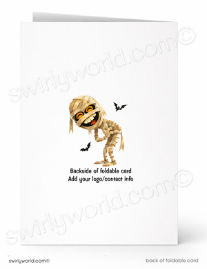A folded greeting card shown front and back on a white background. The front features a cartoon mummy with black bat silhouettes and the text 'Backside of foldable card Add your logo/contact info'.