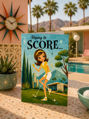 A greeting card featuring a cartoon illustration of a woman playing golf, with a clock and palm trees in the background.
