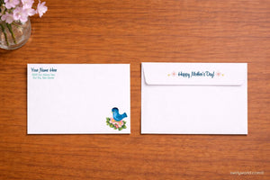 two envelopes on a wooden surface. The left envelope has a blue bird illustration and a message about a mother's day, while the right envelope has a message about happy Mother's Day.