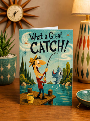 a greeting card with a cartoon illustration of a man fishing, with a fish caught in the net. The card has a playful and humorous design, and the text "What a Great CATCH!" is prominently displayed.