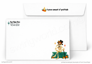 Printed white envelopes shown on a light gray background, with one envelope in front and one behind. The front envelope has a Day of the Dead style skeleton illustration sitting on a green box with orange flowers and a black top hat.