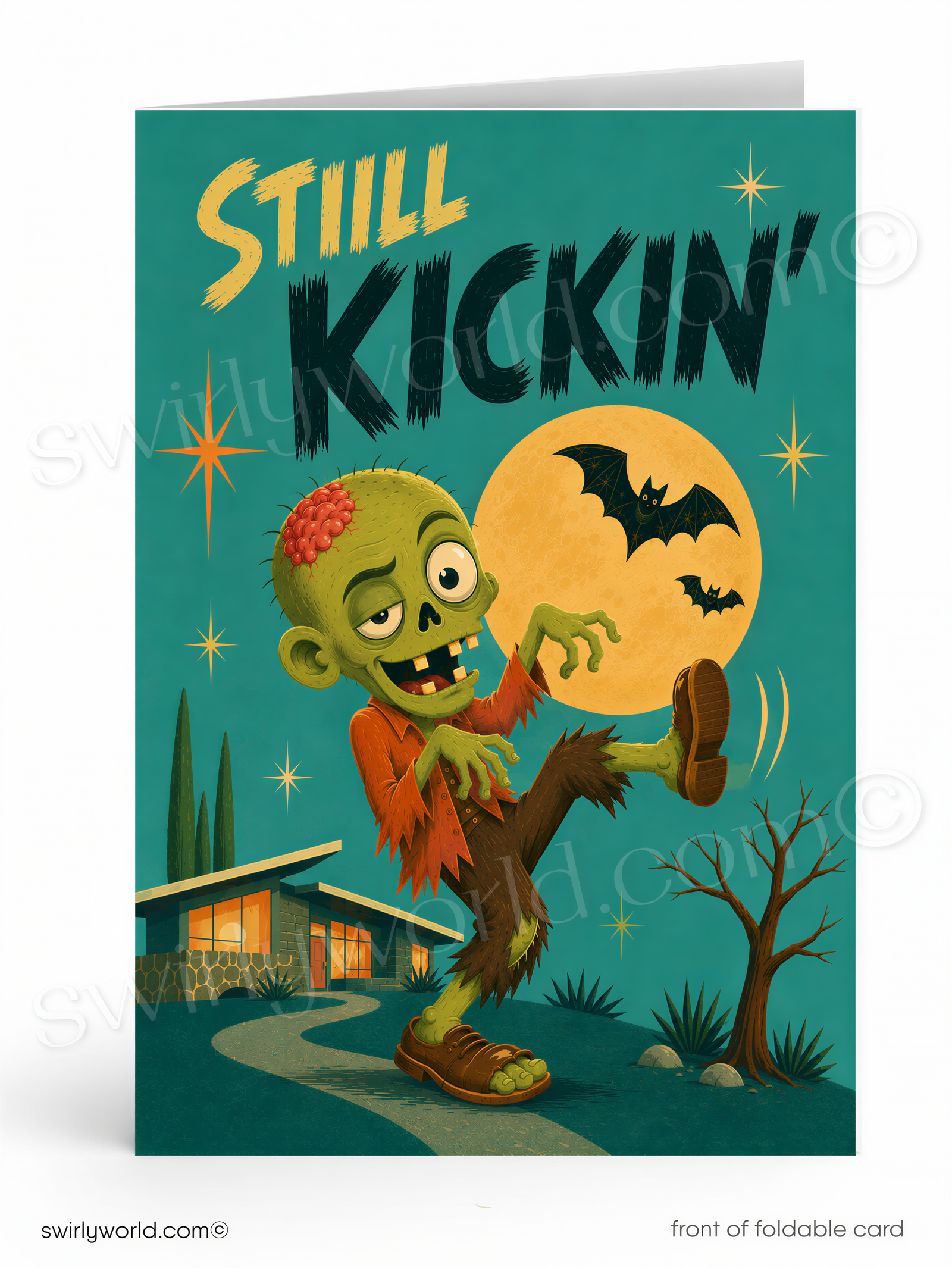 The image is a colorful illustration of a zombie character with a large skull on its head, wearing a red shirt and brown pants, and holding a bat in its hand. The background features a house, trees, and a full moon, creating a spooky and festive atmosphere. The text "STILL KICKIN'" is prominently displayed, and the image is described as a "front of foldable card" with a "swirlworld.com" watermark.
