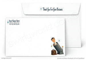 A white stationery set showing the front and back of a printed envelope. The back has placeholder text for name and address, and the front features a small illustration of a businessman wrapped in a suitcase with sparkles.