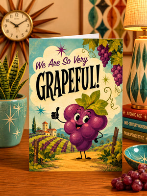 a greeting card with a grape character on it, surrounded by various decorative elements such as a clock, a potted plant, and a bowl of grapes.