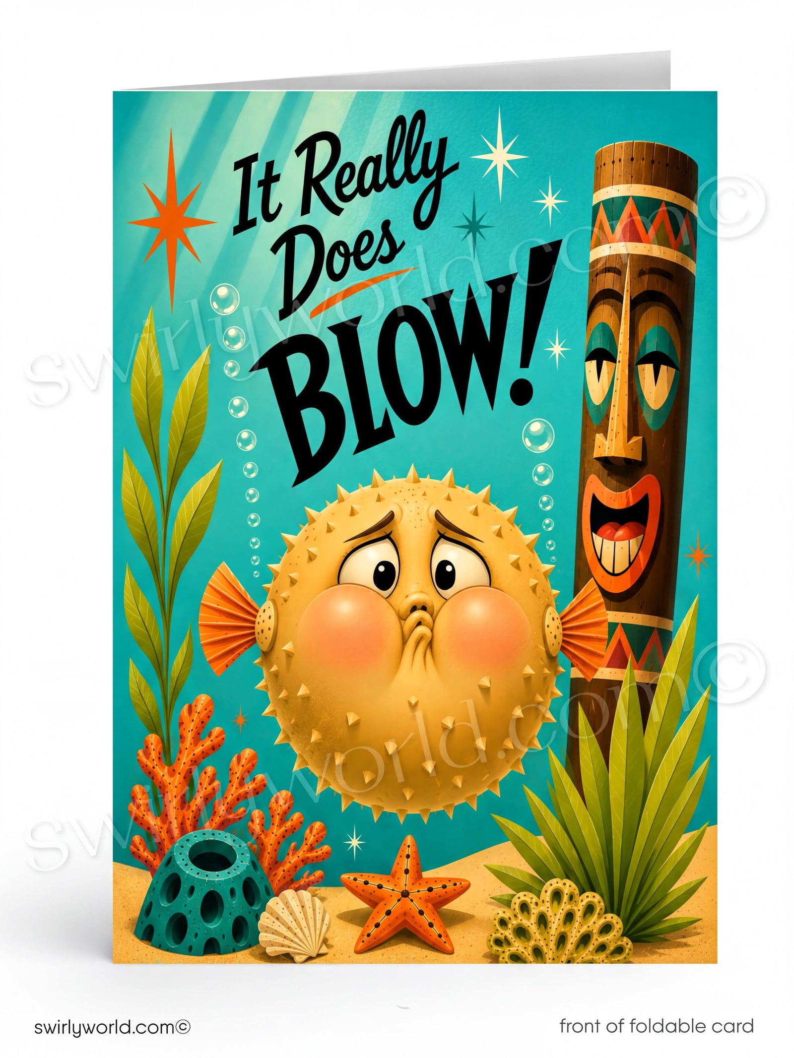 A folded greeting card shown upright on a white background. The card features a colorful underwater scene with a round yellow puffer fish blowing pink cheeks, large black text reading 'It Really Does Blow!', a brown tiki figure, coral, seaweed, and sea urchins.