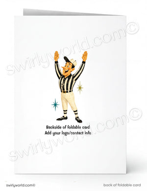 A folded white greeting card shown front and back on a white background. The front has a cartoon referee in a black-and-white striped uniform with raised arms, and the back text reads 'Backside of foldable card Add your logo/contact info.