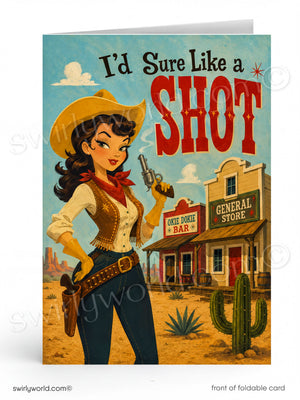 A folded greeting card shown upright on a white background. The card features a retro western illustration with the text 'I’d Sure Like a SHOT' above a woman in a cowboy hat and boots standing in front of a general store and cactus.