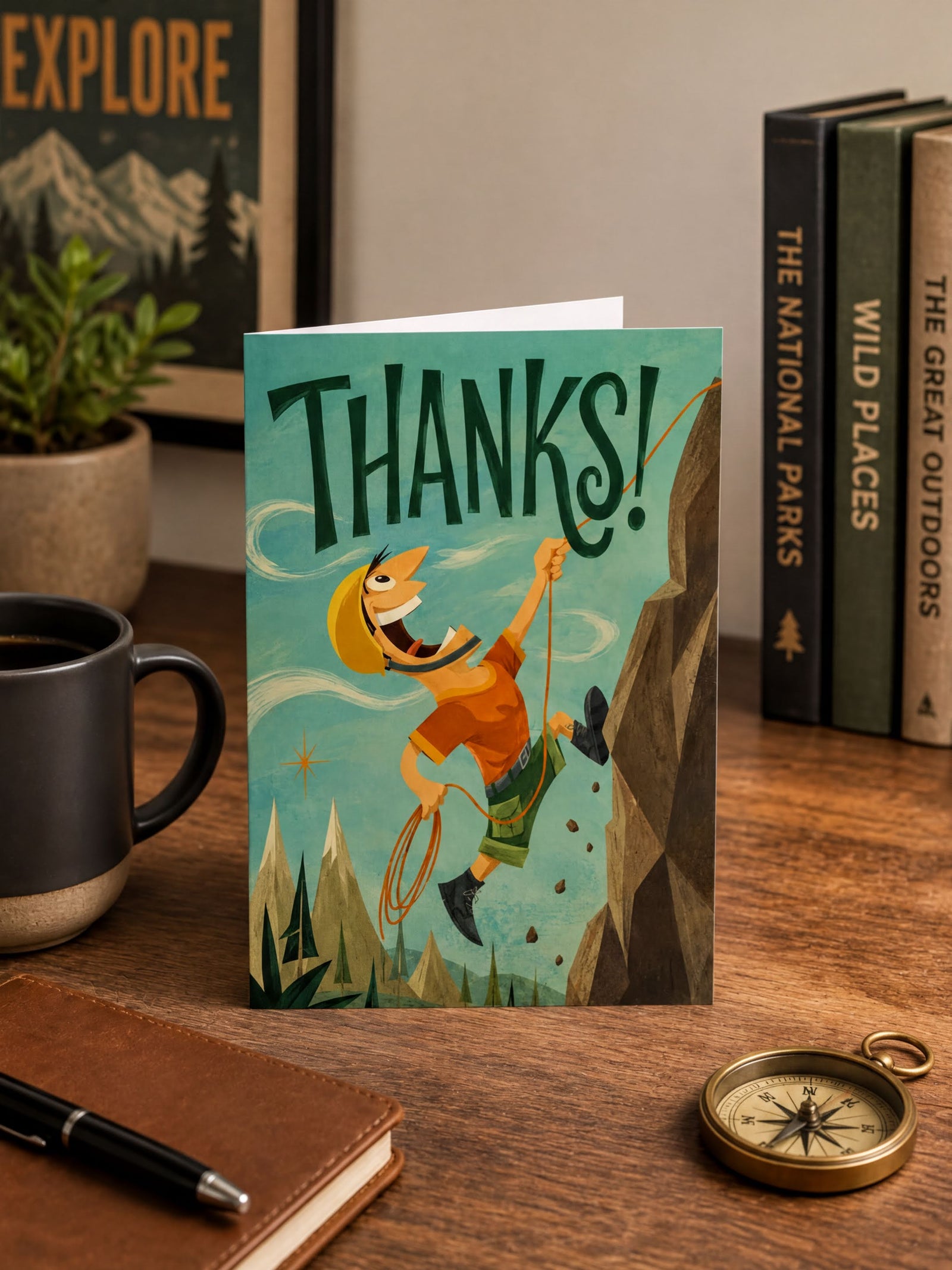 A foldable greeting card shown front-facing on a white background. The card features a retro-style illustration of a smiling rock climber hanging from a rope next to a cliff, with the word 'THANKS!' in large dark green letters across the top.