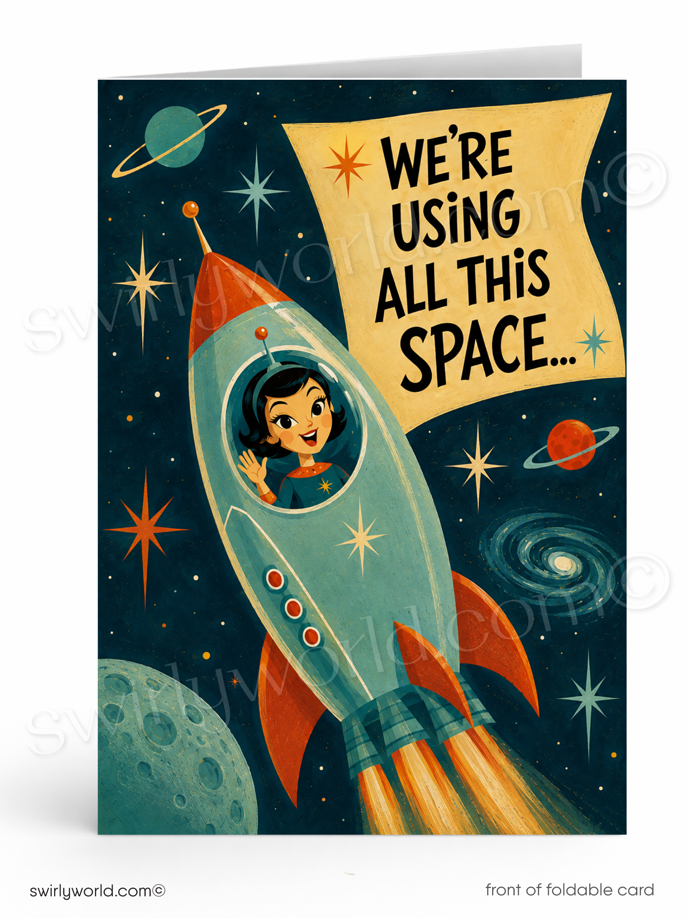 A foldable greeting card shown upright on a white background. The card front features a retro space illustration with a teal rocket carrying a child astronaut, planets, stars, and a yellow banner that reads, 'WE'RE USING ALL THIS SPACE.