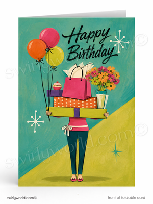 A folded birthday card shown front-facing on a white background. The card features an illustrated person carrying gift boxes, balloons, flowers, and a cupcake against a teal and yellow background, with the text 'Happy Birthday' in black script.