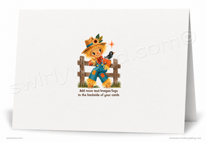 A folded white greeting card shown standing upright, with a printed illustration of a strawman scarecrow sitting on a wooden fence and holding a red bird. Small text appears below the illustration, and a large diagonal watermark is visible across the card.