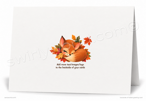A white folded greeting card shown standing open against a white background. The back side features a watercolor-style illustration of a sleeping orange fox nestled among autumn leaves, with placeholder text below.