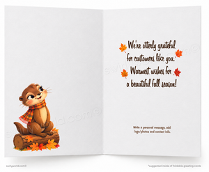 An open greeting card with a white interior. The left side shows a cartoon beaver wearing a red and orange plaid scarf, sitting on a log with autumn leaves.