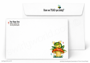 A white printed envelope set shown on a light gray background. The front envelope has a cartoon frog sitting on a red mushroom with small blue sparkle accents, and the back envelope has the phrase 'Have we TOAD you lately?' with a small bee above it.