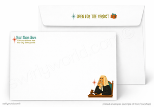 A printed envelope set shown on a white background, with one envelope closed in back and one open envelope in front. The front envelope has a small illustrated judge in a robe and gavel, and the back envelope has placeholder text including 'Your Name Here' and 'Your City State Address.