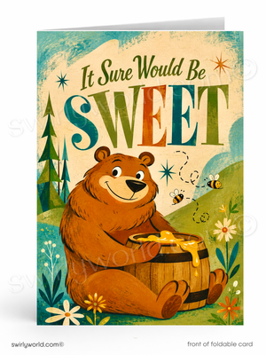 A folded greeting card shown upright on a white background. The front features a whimsical illustration of a brown bear sitting by a honey pot, with bees, flowers, trees, and the text 'It Sure Would Be SWEET' in large decorative letters.