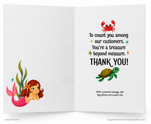 An open greeting card with a white interior. The left page shows a cartoon mermaid with a pink tail and green seaweed.