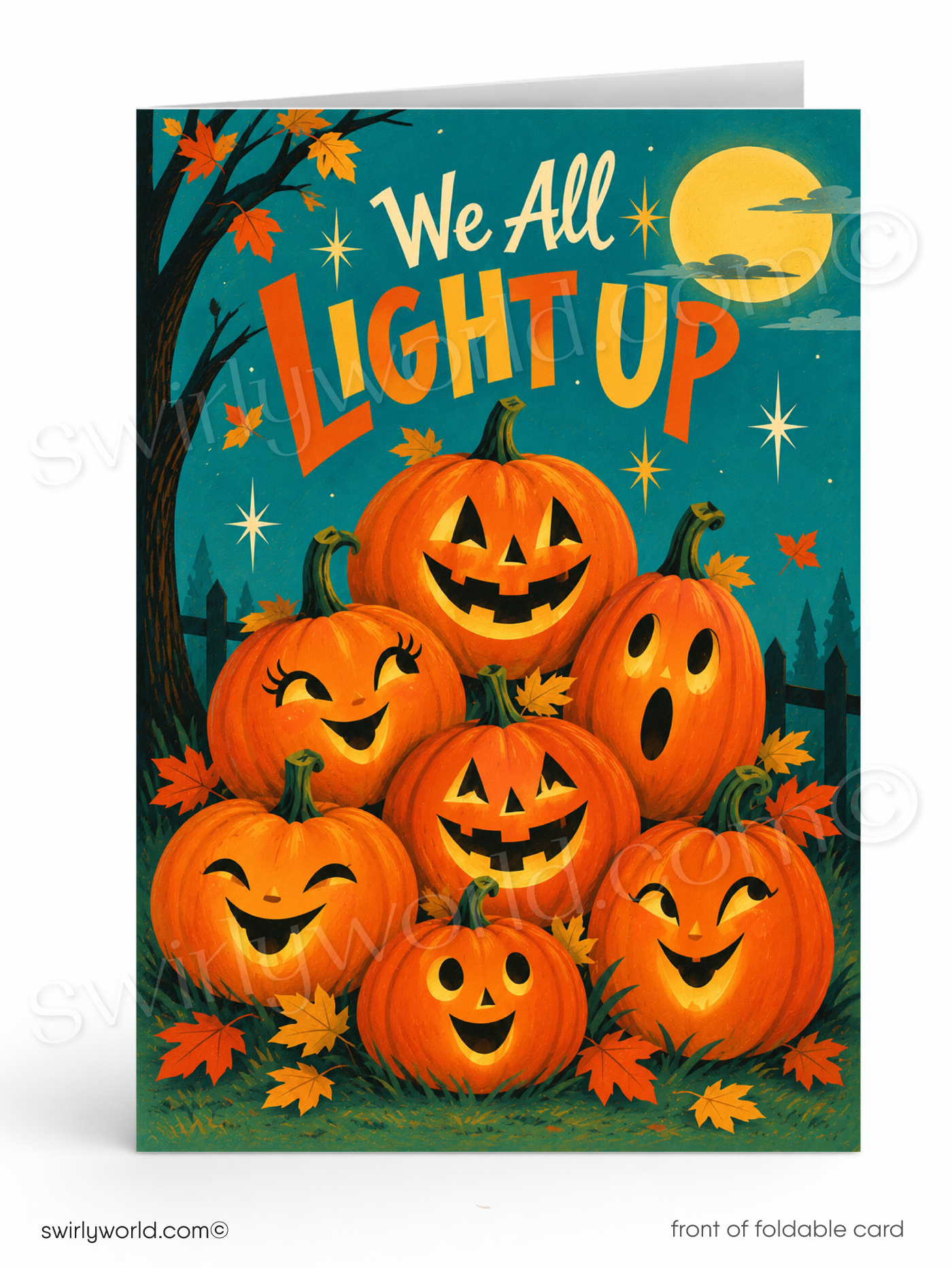 A folded Halloween greeting card shown upright on a white background. The card features a colorful illustration of seven glowing jack-o'-lantern pumpkins, autumn leaves, a tree, stars, and a full moon with the phrase 'We All Light Up' in large orange letters.
