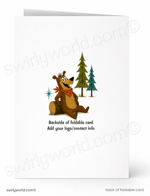 A folded white greeting card shown front and back on a white background. The front features a cartoon brown bear sitting on a log with pine trees and a red scarf, while the back text reads 'Backside of foldable card Add your logo/contact info'.