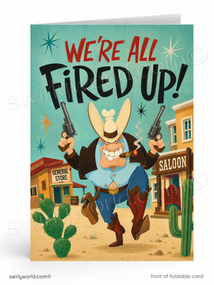 A folded greeting card shown front-facing on a white background. The card features a western cartoon scene with a cowboy holding two revolvers and smoking a cigar, under the text 'WE'RE ALL FIRED UP!' in red and black lettering.