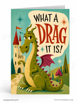 A foldable greeting card featuring a whimsical illustration of a green dragon sitting in front of a castle, with the text 'WHAT A DRAG IT IS!' in large decorative lettering. The card is shown standing upright against a white background.