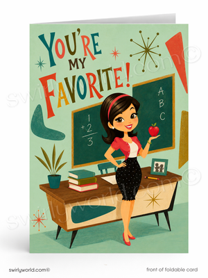 A folded greeting card shown upright on a white background. The card features a retro-style illustration of a smiling woman standing in a classroom, holding an apple near a chalkboard and desk.