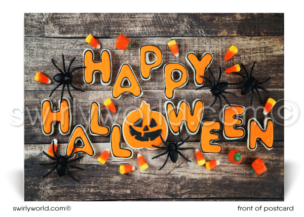 This postcard design features a whimsical "HAPPY HALLOWEEN" message adorned with spooky spiders and candy corn, set against a rustic wood backdrop